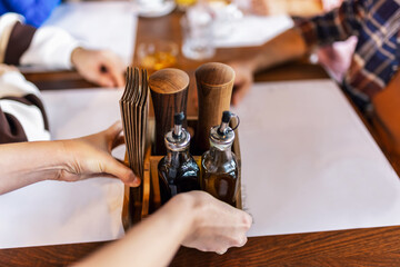 Table set in a restaurant. Olive oil and vinegar and napkin holder. Food and drink concept.