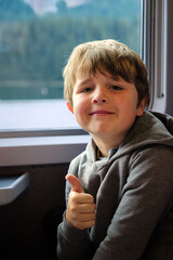 happy 8 year old boy giving thumbs up, radiating positivity and sense of accomplishment