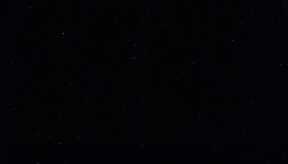Fototapeta premium Starry night sky in deep black with small scattered stars