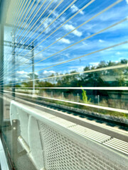 A view through a glass window on a train platform