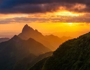 Obraz premium dramatic sunset casting golden light on lush mountain peaks against a stunning sky evoking the power of nature