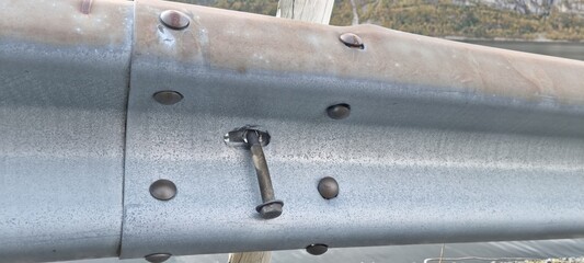 road guardrail with loose screw danger
