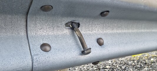 road guardrail with loose screw danger