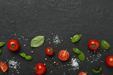 Fresh tomatoes, basil, sea salt and spices on concrete background, top view