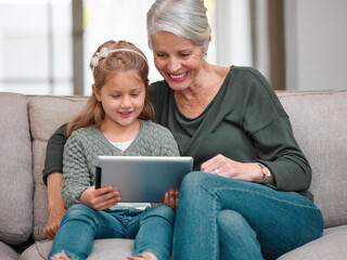 House, grandmother and girl on sofa, tablet and typing with smile, bonding together and care in...