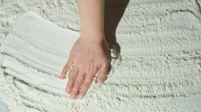 The cooking background is drawn by the hand over the wheat flour, top view, space for the text.