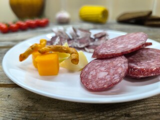 white plate with sliced salami. High quality photo