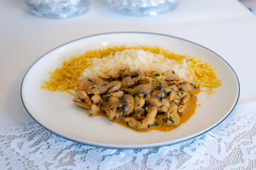 Traditional chicken stroganoff with mushrooms, straw potatoes and white rice