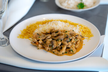 Traditional chicken stroganoff with mushrooms, straw potatoes and white rice