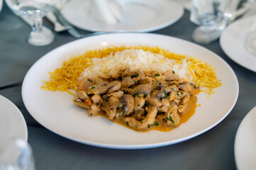 Traditional chicken stroganoff with mushrooms, straw potatoes and white rice