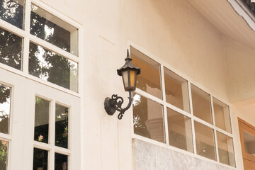 Old fashioned street light on the wall with window,Cozy house exterior,Large estate home building...