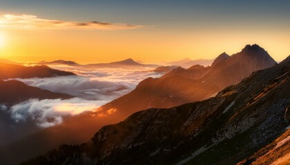 Obraz premium majestic mountain range bathed in golden sunrise with misty clouds