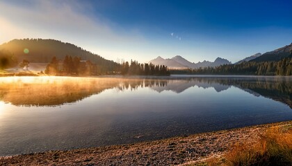 tranquil mountain lake with fog at sunrise