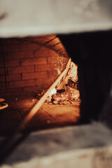 Close-up of the door of a traditional wood-fired oven. Ideal for ads emphasizing authentic preparation techniques.