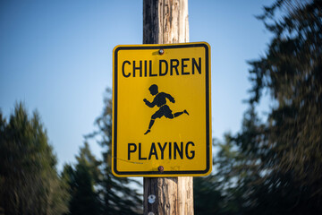 Children Playing sign on a post.