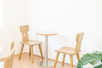 Empty wooden chairs and table in dining room,tropical plants and elegant personal accessories in stylish home decor,Template..