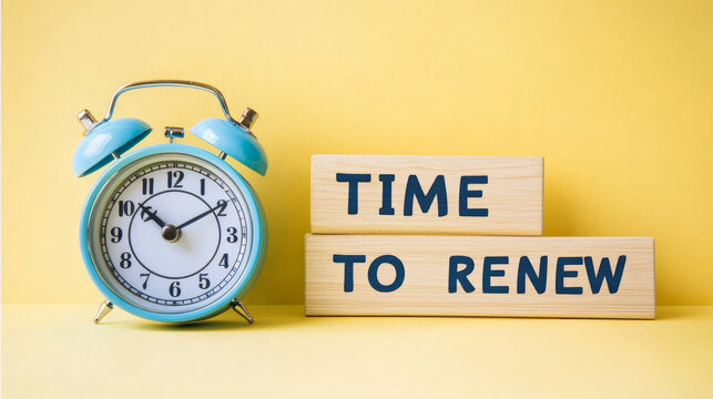 Time to renew, text in a gold frame on a pink background, near an alarm clock. Business, strategies, plans, and goals concepts.

