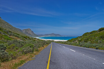 Outdoor, empty and scenery of route, road and path in nature, blue sky and way for journey and trip. Highway, travel and sightseeing of mountain, mockup and environment of beach, water and California