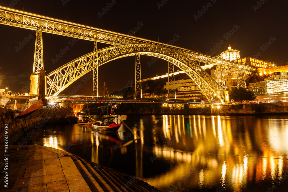 Wall mural view of the beautiful steel bridge over the duero river in porto in the evening