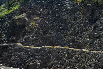 Part of the original White Pass trail heading up from Skagway Alaska to the Klondike gold rush of the 1890s, seen from the White Pass and Yukon Route train.