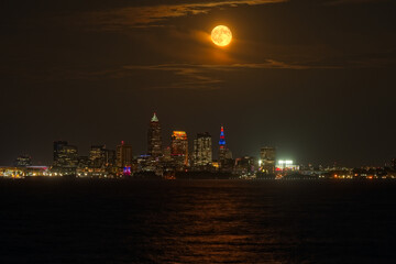 A September full moon rises above Cleveland, Ohio, and Lake Erie