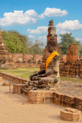 Buddhafigur mit gelber Schärpe in der historischen Tempelanlage Wat Phra Sri Sanphet in Ayutthaya