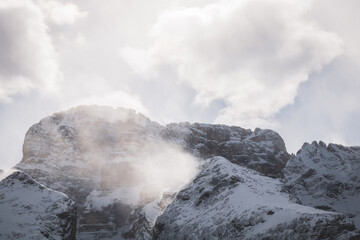 Close-up of snowdrifts on a snowy peak close to the Croda Rossa d'Ampezzo on a sunny day with a blue sky in the Dolomites. View from the Forte di Prato Piazza on Duerrenstein.