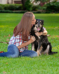 Dog getting kiss from human