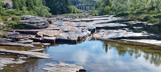 low water level in dammed river stream from mountain