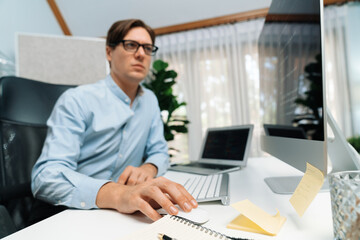 Obraz premium IT developer looking at online software development information on pc align working laptop with coding program on updated version application project trial creating new code overall system. Pecuniary.