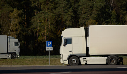 a white truck is parked, the driver is resting, observing the work and rest schedule