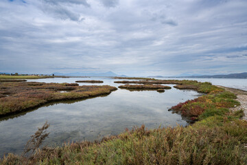 Beautiful landscape of a lagoon at Greece. Cloudy sky at the background.