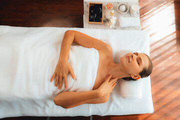 Obraz premium Panorama top view woman customer enjoying relaxing anti-stress spa massage and pampering with beauty skin recreation leisure in day light ambient salon spa at luxury resort or hotel. Quiescent