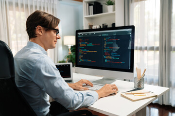 IT developer working online software development information on pc and laptop screen with typing to create new code program on updated version application project creating overall system. Pecuniary.