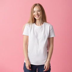 Obraz premium Lifestyle concept. A happy young lady with white t-shirt stands against a pink background