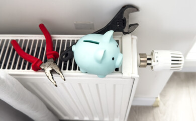 Plumber installing new steel hot water central heating radiator at home