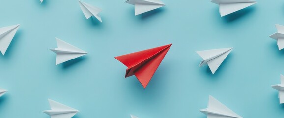 Red Paper Airplane Standing Out from White Paper Airplanes