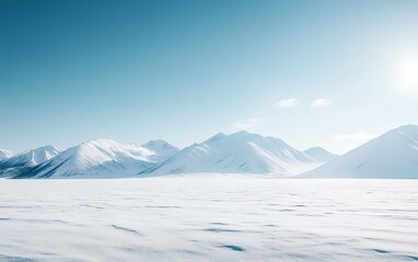 Fototapeta premium A breathtaking winter landscape featuring majestic snow-capped mountains rising above a vast frozen plain under a clear blue sky