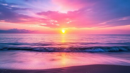 Fototapeta premium Serene Sunset Seascape: A breathtaking sunset paints the sky in vibrant hues of pink and purple, casting a warm glow on the tranquil ocean waves. The scene evokes a sense of peace, tranquility.