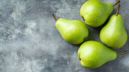 A green conference pear is placed in the center of a grey background, captured with full depth of field for maximum detail. 