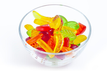 Fruit jelly candies in glass plate on the white background