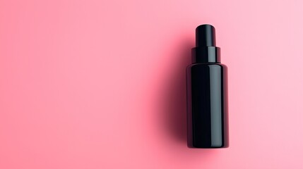 Obraz premium black bottle of serum on pink background with empty copy space
