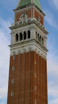 Bell tower in Venice, Italy - Stabilized shot panning up to the top of the campanile bell tower in Piazza San Marco, Venice, Italy showing detailed architectural arts of historical building exterior.