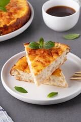 Delicious homemade apple pie served with coffee and garnished with mint leaves on a cozy kitchen table