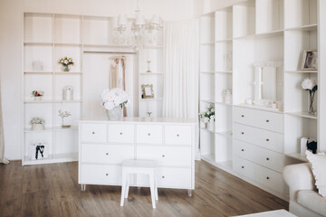 Elegant wedding dress, shoes and bouquet in room