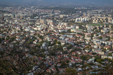 Fototapeta premium Skopje, a thriving urban panorama The city of Skopje, seen from above Aerial view of the Macedonian capital Skopje, a mosaic of colors and shapes where the mountains meet the metropolis.