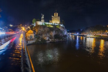 Night view over the Kura River in Tbilisi, Georgia, with city lights reflecting on the water © Aquarius