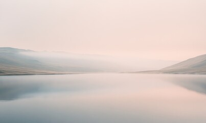 A calm lake with a foggy sky in the background