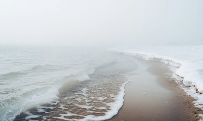 A foggy, misty day at the beach with a cold ocean