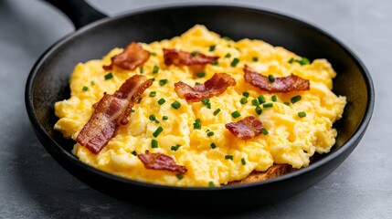 A whisk mixing eggs, milk, and a pinch of salt for fluffy scrambled eggs, with butter melting in a nonstick skillet over medium-low heat.